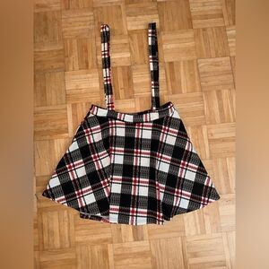 Black and red plaid mini skirt with suspenders.